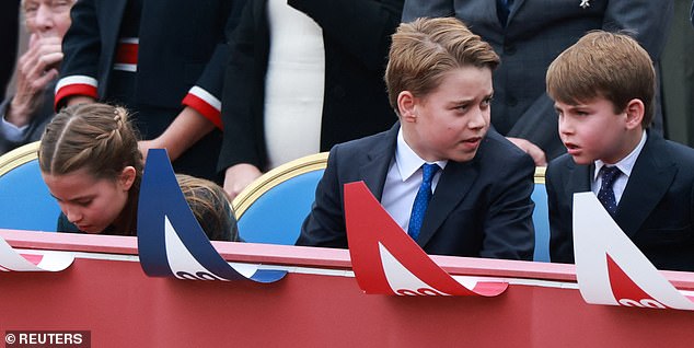 The future king was pictured sitting between his younger siblings Princess Charlotte and Prince Louis