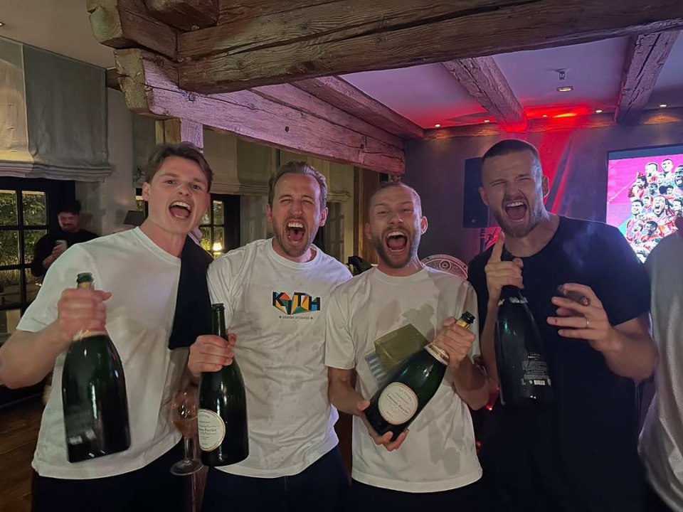 Four Bayern Munich players celebrating with champagne.
