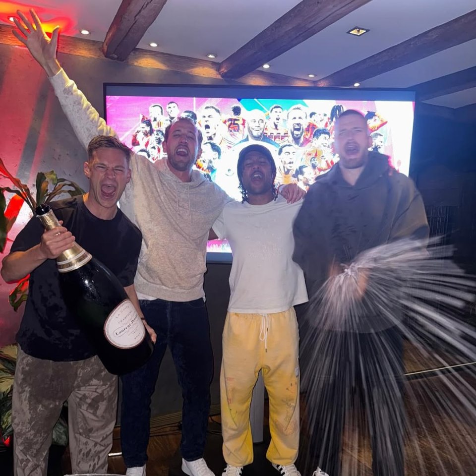 Harry Kane celebrating a trophy win with friends.