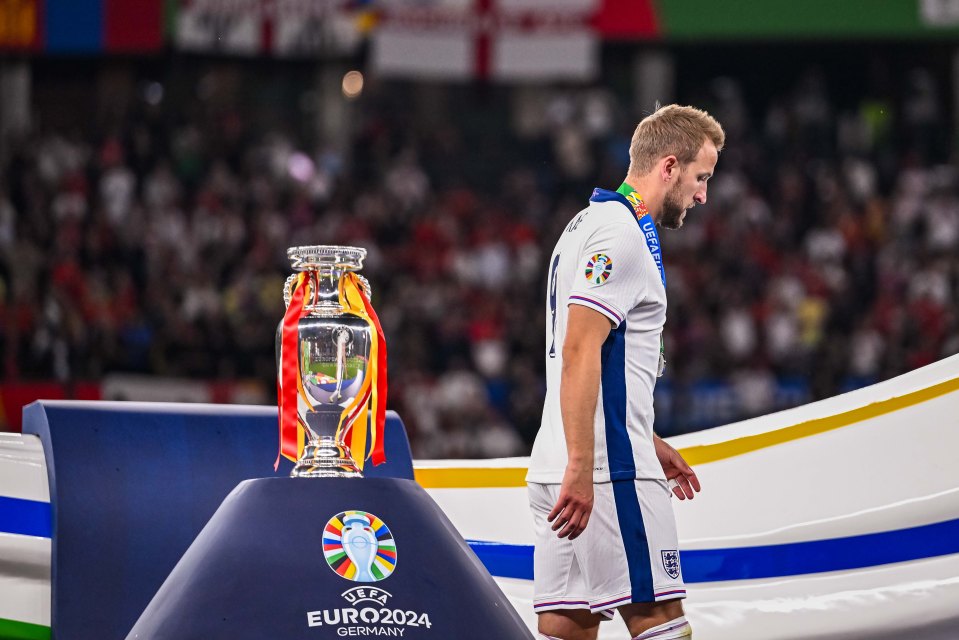 Harry Kane of England walks past the UEFA Euro 2024 Henri Delaunay Trophy after the final match.