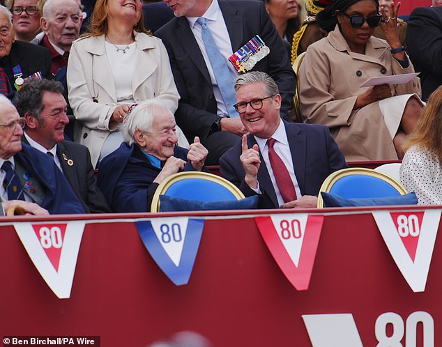 Prime Minister Sir Keir Starmer speaks to Second World War veteran Albert Keir ahead of the military procession for the 80th anniversary of VE Day