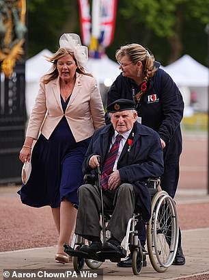 Alfred Littlefield, aged 101, joined the Royal Engineers and served during D-Day, when he swam in with supplies from the launches under shell fire. Above: Mr Littlefield being pushed in his wheelchair into Buckingham Palace today