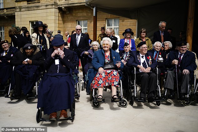 Frederick Pickering (left), Betty Hollingberry (centre), Francis Grant known as Jim Grant (second from right) and Alfred Littlefield (right) on the West Terrace in the gardens of Buckingham Palace to view the fly past today