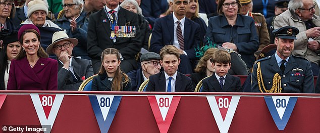 The Wales children looked serious as they watched the parade while their parents beamed