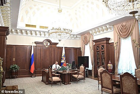 Pictured: Russian President Vladimir Putin in his office inside the Kremlin
