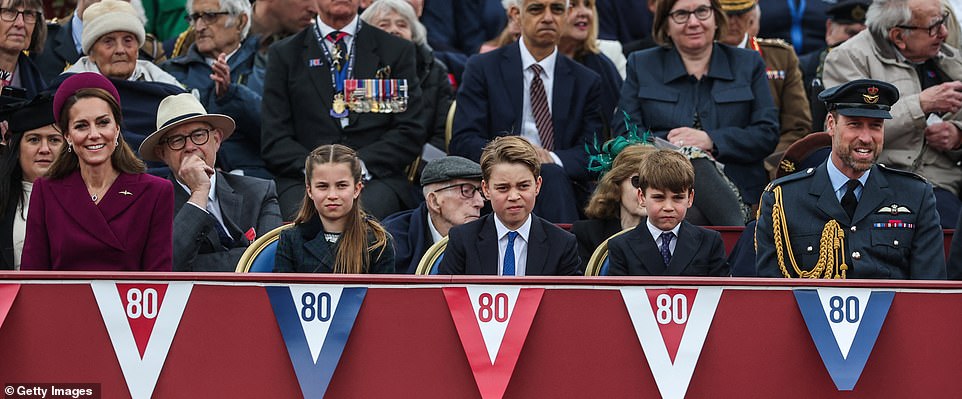 The Wales children looked serious as they watched the parade while their parents beamed