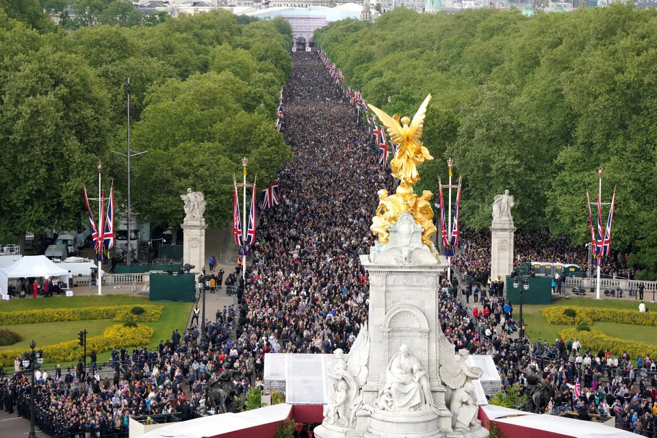 Large crowd on The Mall near Buckingham Palace during VE Day anniversary.
