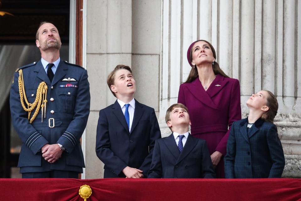 Prince William, Princess Catherine, and their three children watching a flypast from Buckingham Palace balcony.