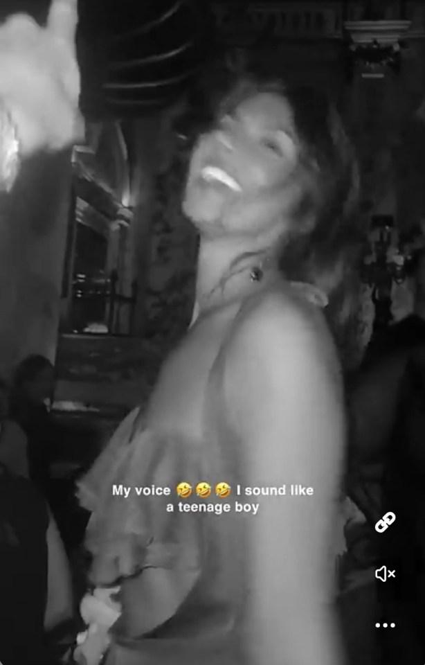 Black and white video of a woman laughing in a car, with text overlay saying "My voice 😂 I sound like a teenage boy".