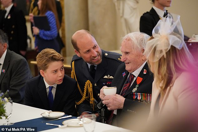 George was attentively listening as he and his father chatted with World War II veterans during the tea party