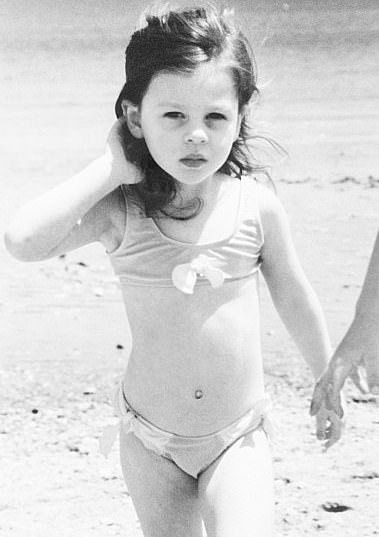 Nicola as a young girl on a Californian beach in a two-piece swimsuit