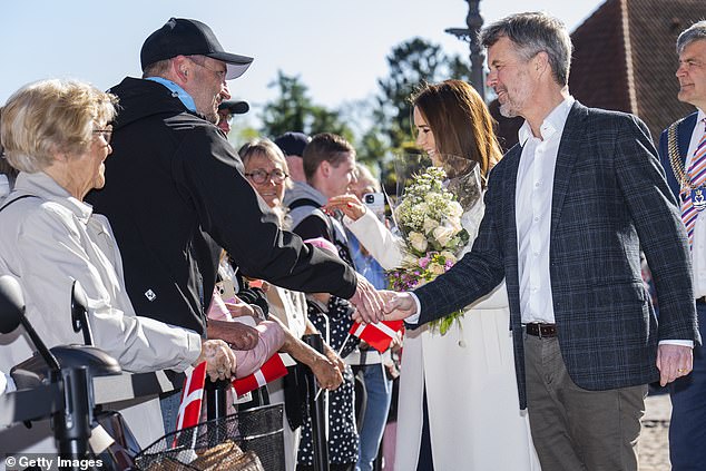 Elsewhere King Frederik donned taupe chinos with a pastel blouse, topped with a checkered blazer