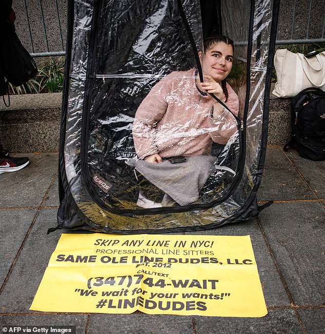 A place holder waits on line for access to the courtroom on Monday, May 5