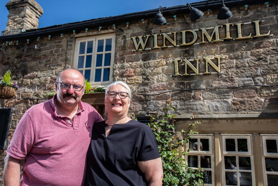 Michelle Landers and Rob Lamb, the new landlords of the Windmill Inn, stand in front of the pub.