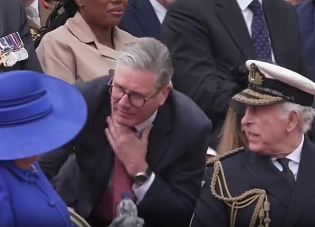 He knelt to pick up a bottle of water, handing it to Camilla while gesturing to his own throat (pictured)