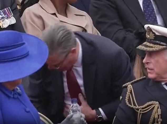 The wife of King Charles, 77, was seated next to the monarch as the couple watched the military procession on Monday - when she suddenly appeared to suffer a coughing fit. The politician, 62, who was seated in the row behind, quickly stood up and reached down to help Her Majesty with a drink to help