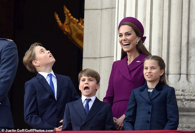Prince George, Prince Louis, the Princess of Wales and Princess Charlotte watch the flypast at Buckingham Palace today