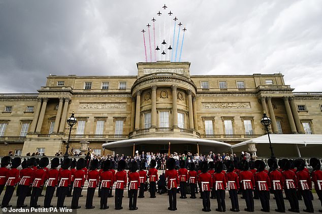 Veterans and members of the armed forces on the West Terrace in the gardens of Buckingham Palace this afternoon