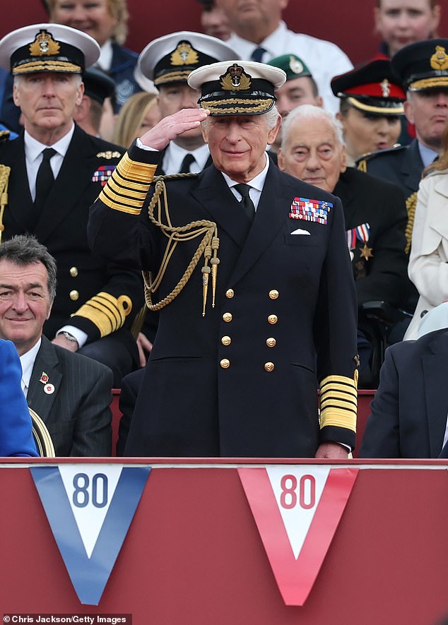 King Charles III salutes during the military procession to mark the 80th anniversary of VE Day in London today