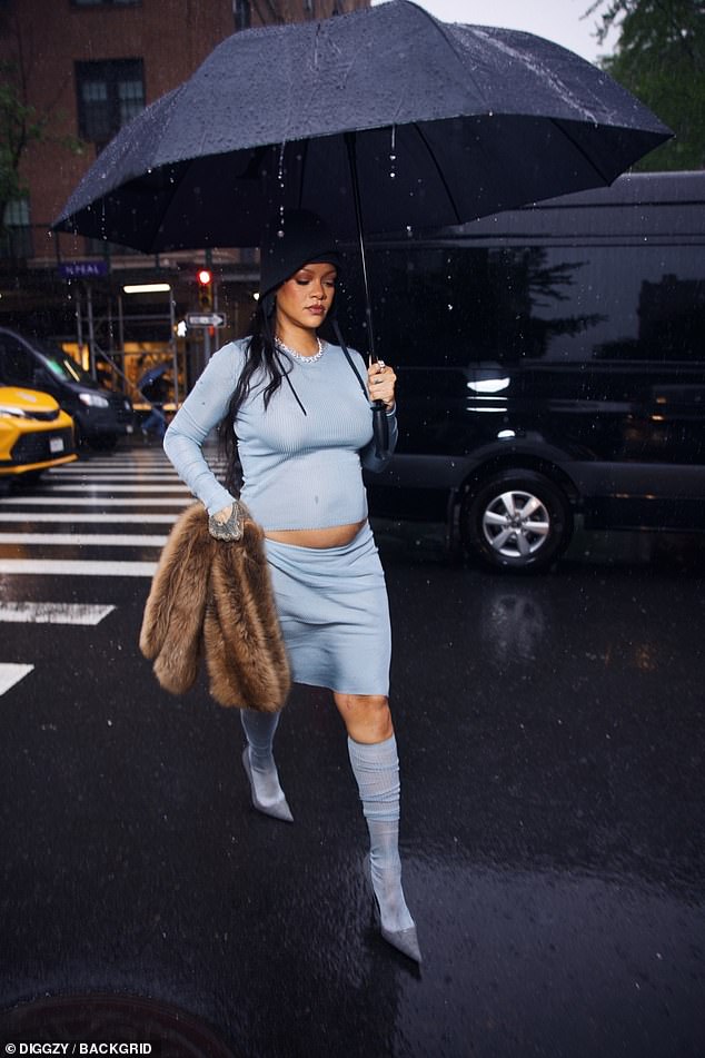 The singer was photographed wearing a light blue Miu Miu long sleeve shirt and matching knee-length skirt outside The Carlyle Hotel