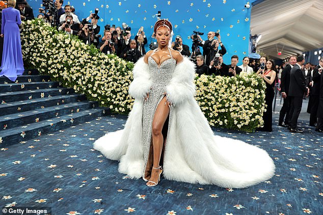 Megan Thee Stallion wowed in a busty silver gown, paired with a furry white coat