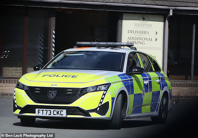 A police car was parked outside the site when MailOnline visited one midweek afternoon