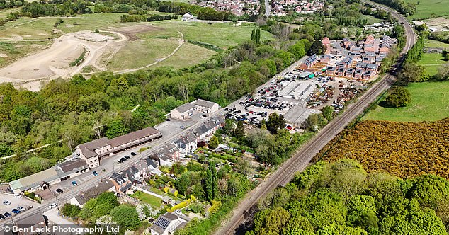 An aerial view of the hotel (on the left) with houses opposite