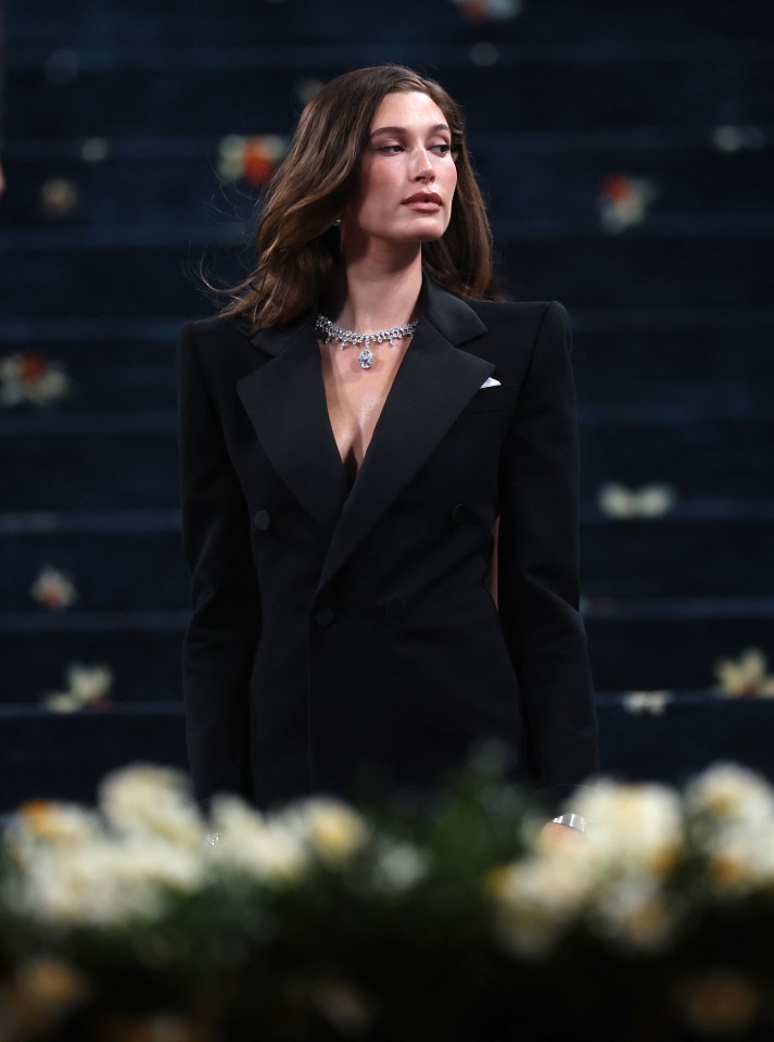 Hailey Bieber at the Met Gala in a black tuxedo.