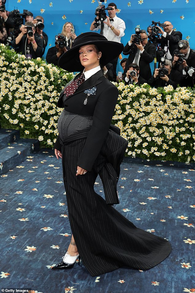 Billionaire Rihanna — who is expecting her first child with A$AP Rocky — walked the red carpet in a black pinstripe outfit that looked similar to other looks at the event