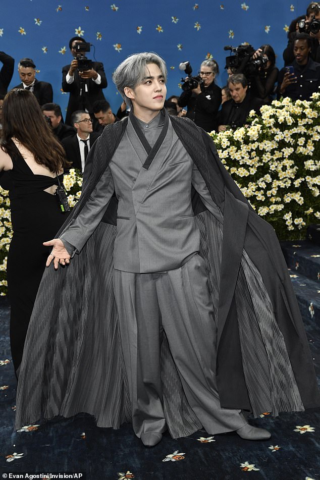 S.Coups suited up in gray but added drama to the look with an oversized, floor-length coat