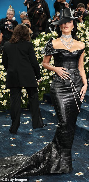 Kim went hell for leather in a long bodycon dress with matching large fedora by Chrome Hearts