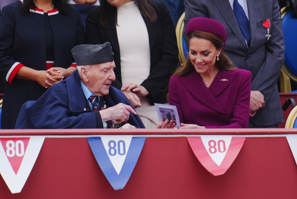 The Princess of Wales looking at a photo with a World War II veteran at a VE Day anniversary event.