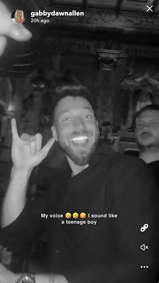 Black and white video of Sam Thompson making a hand gesture.