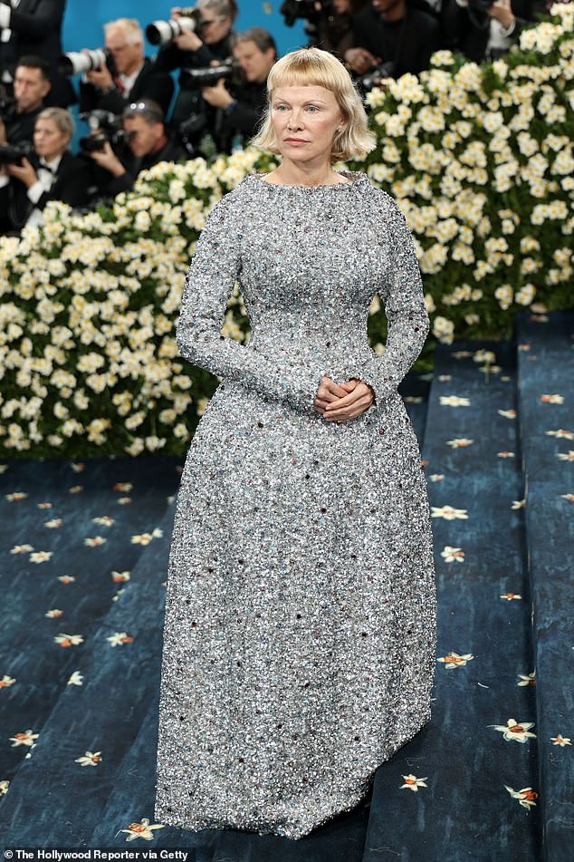 The former Playboy pinup showed off a conservative new hairdo paired with a long-sleeve grey gown while arriving at the at Metropolitan Museum of Art