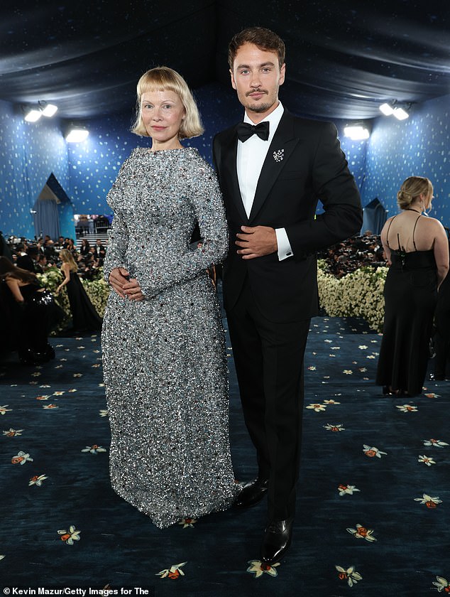 Meanwhile Brandon, whom she shares with rocker ex Tommy Lee , looked dapper in a classic black tuxedo