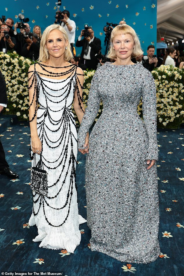 She also posed with the designer of her gown, Tory, 58, at the event