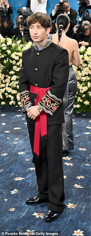 Oscar nominee Keoghan opted for a Valentino black suit with dramatic red sash and bejeweled sleeves and collar