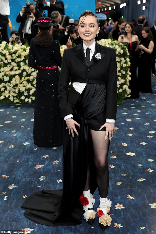 The English actress was seen looking stunning in a black-and-white deconstructed suit with a long black train draped to her side