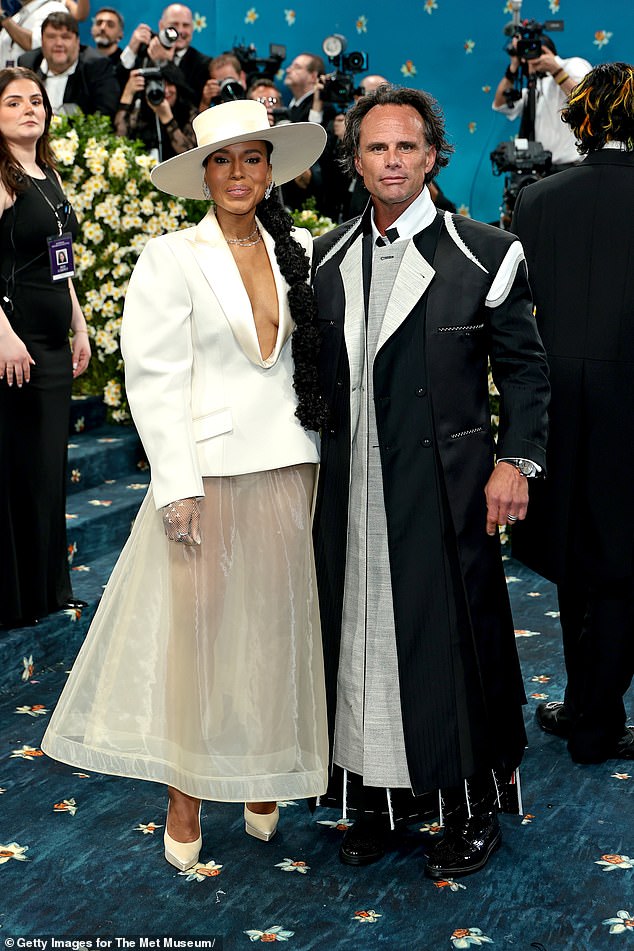 The outer layer of his jacket also appeared to intentionally separate from the inner lining to reveal the canvas layer in between that helps to structure a high-end suit jacket; he's pictured posing with Kerry Washington on the red carpet