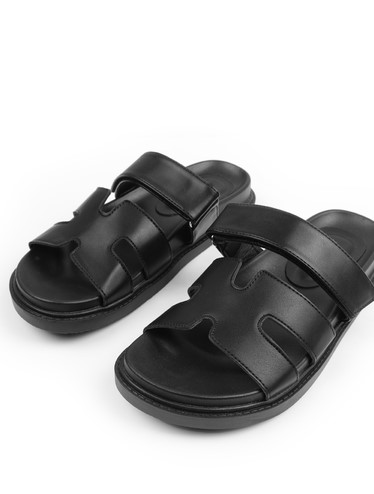 Pair of black leather sandals with double straps.