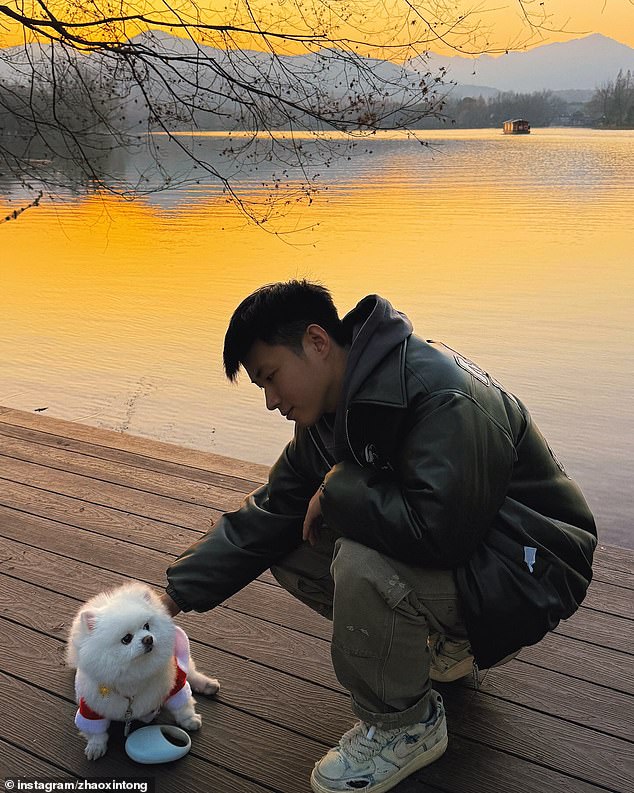 He is pictured here with his dog at a lake in China in January - a few months after returning to the sport