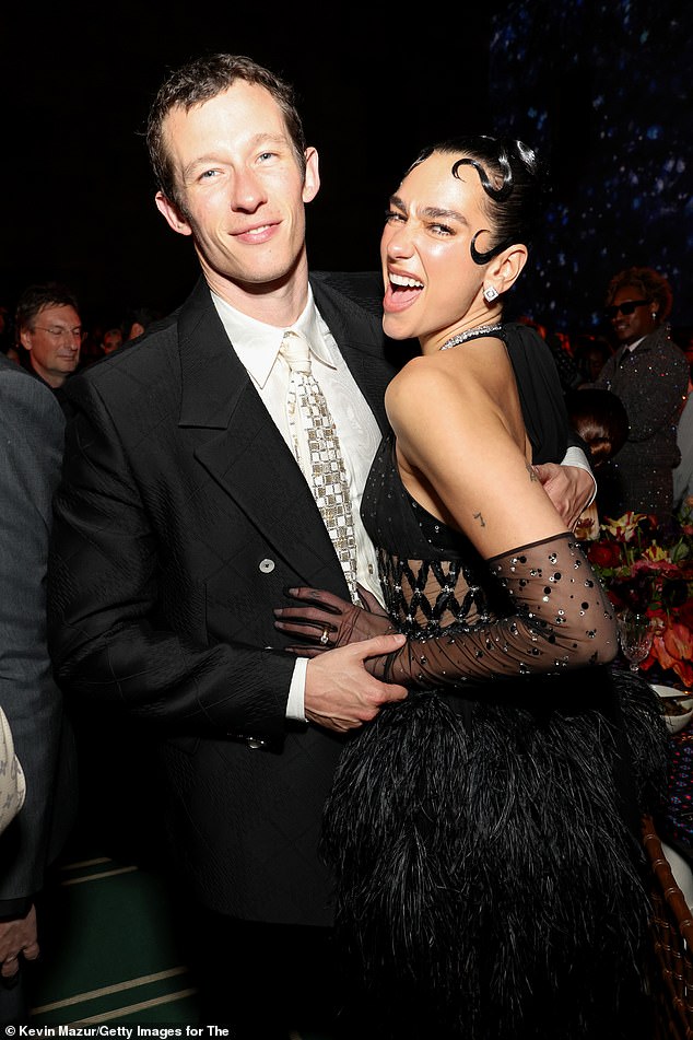 Dua Lipa got handsy with her boyfriend Callum Turner as the party began