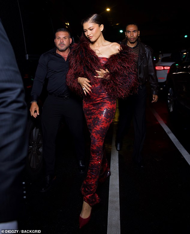 Opting for a form-fitting red Bardot dress and matching heels, Zendaya looked typically stunning while exiting her Manhattan hotel flanked by bodyguards