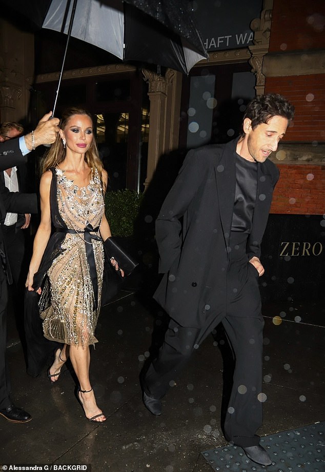 Meanwhile Adrien Brody and Georgina Chapman dodged the rain as they made their way back to their New York hotel on Monday evening