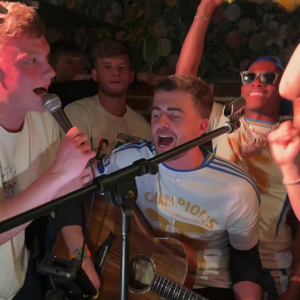 Leeds United players singing and playing guitar.