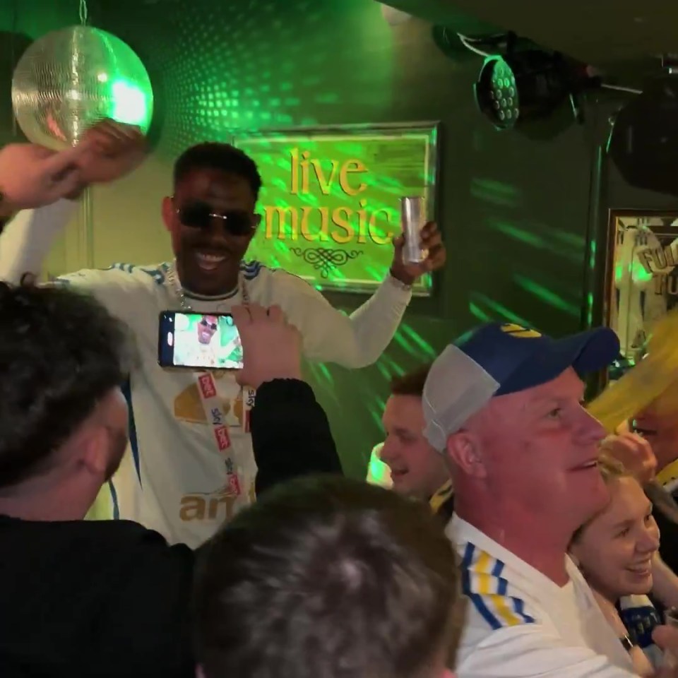 Leeds United players celebrating in a pub.