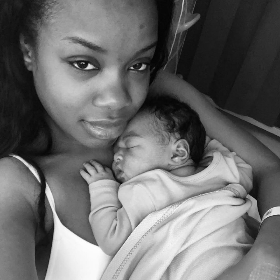 Black and white photo of a mother holding her newborn baby.