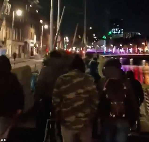 In other clips, a large group of men can be seen patrolling the roads to keep the city 'safe'