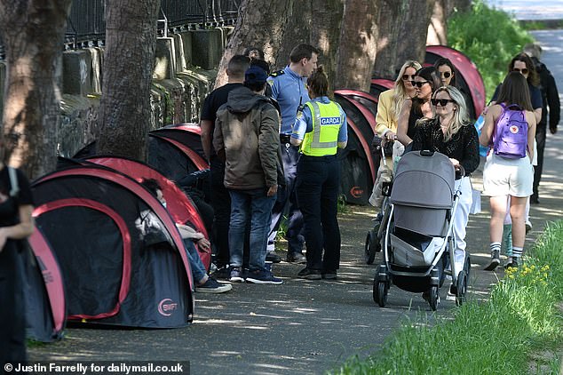 When MailOnline visited the area last year the contrast in Dublin was stark. As friends and families soaked up the sunshine along the tranquil Grand Canal on Friday, migrants were being quizzed by police in their tents on the footpath
