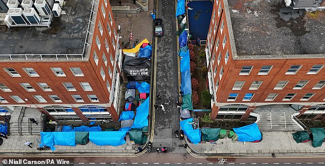 The string of makeshift accommodation stretching around the International Protection Office and continuing along the road, was dubbed a 'tent city'